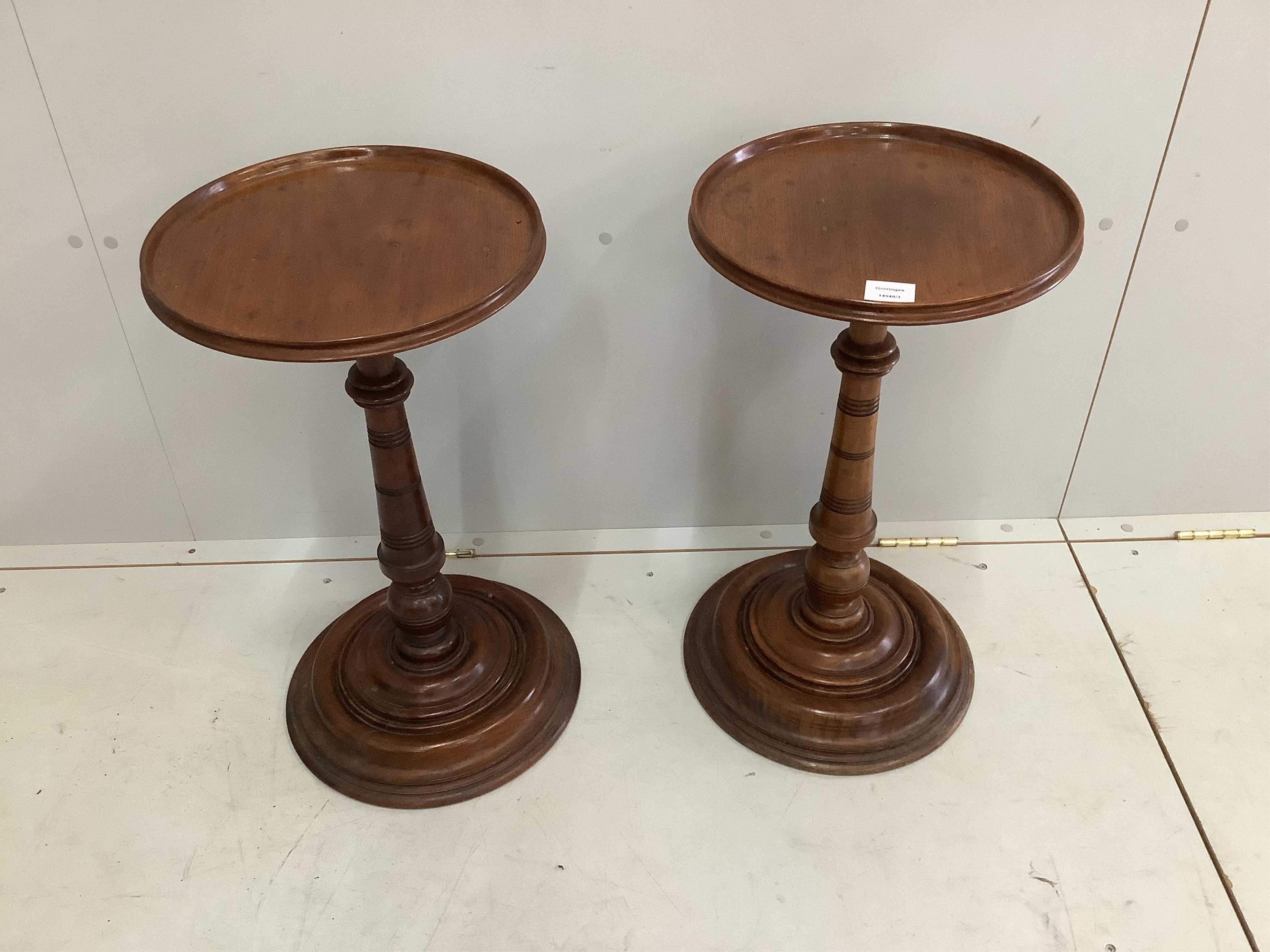 A pair of late Victorian circular mahogany wine tables, diameter 35cm, height 63cm. Condition - fair